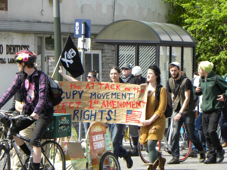 a protest on a bicycle in front of a building