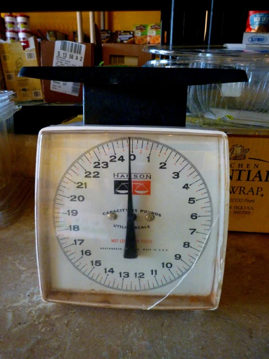 a box with a black lid and an analog timer sitting in it