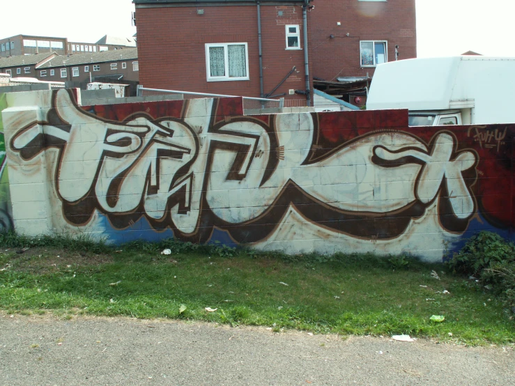 a wall with graffiti is shown in the foreground