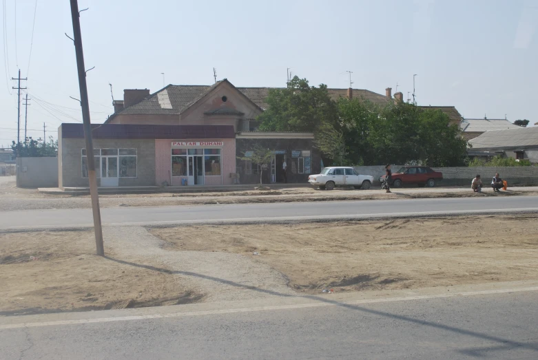 a small building sits next to a road