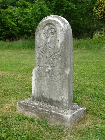 this is a grave in a cemetery in the grass