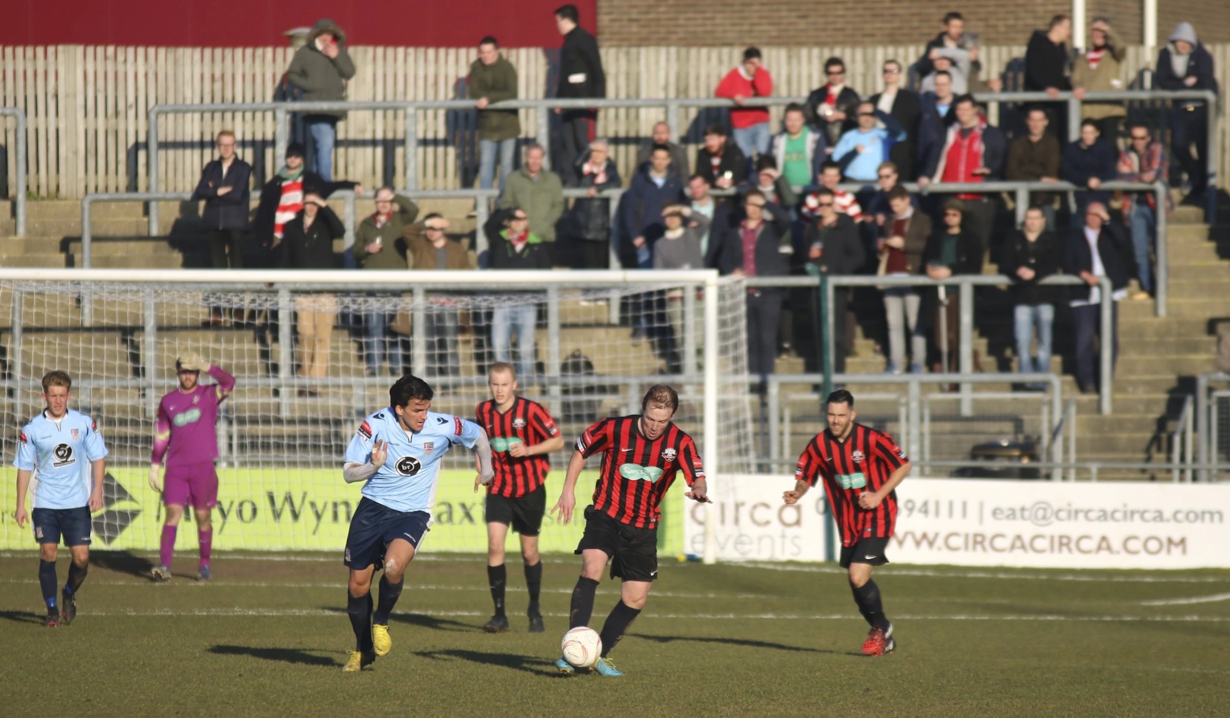 a soccer game with players going after the ball