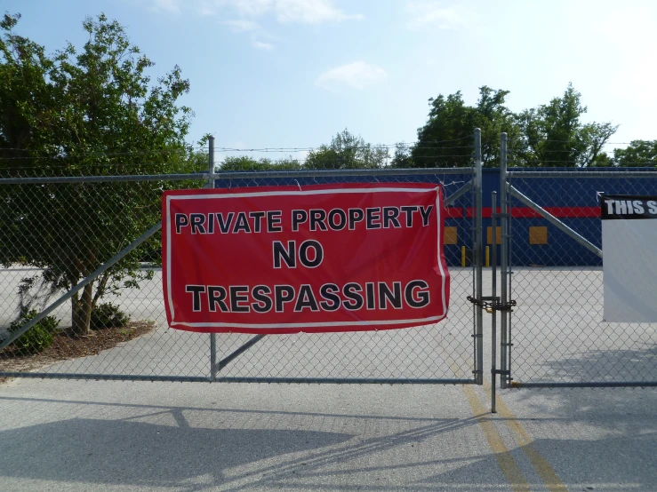 there is a red sign that says private property no trespassing