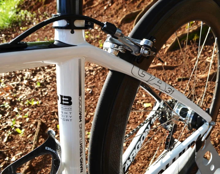 a close up s of a bike parked on a dirt ground