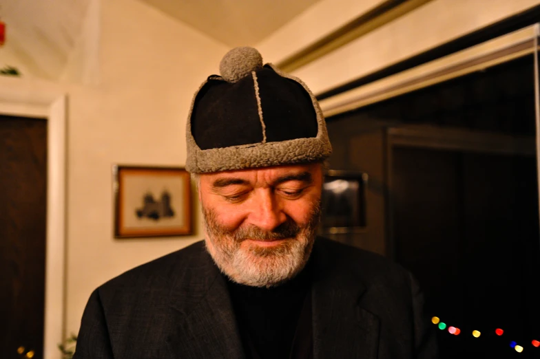 a man in a black suit wearing a hat