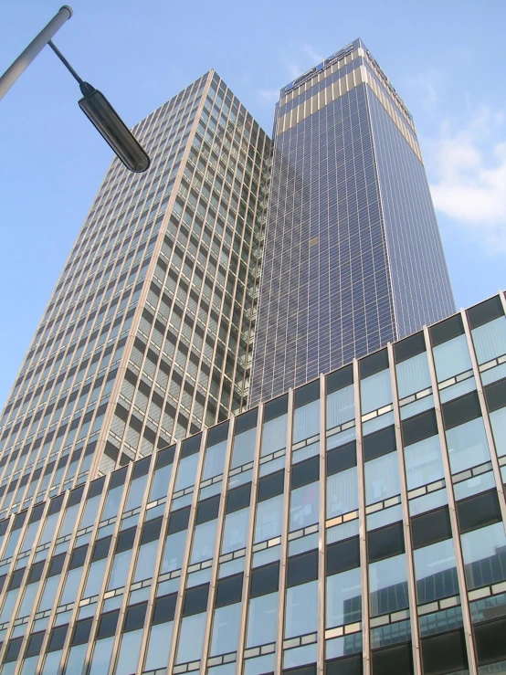 skyscrs sit against a blue sky on the other side