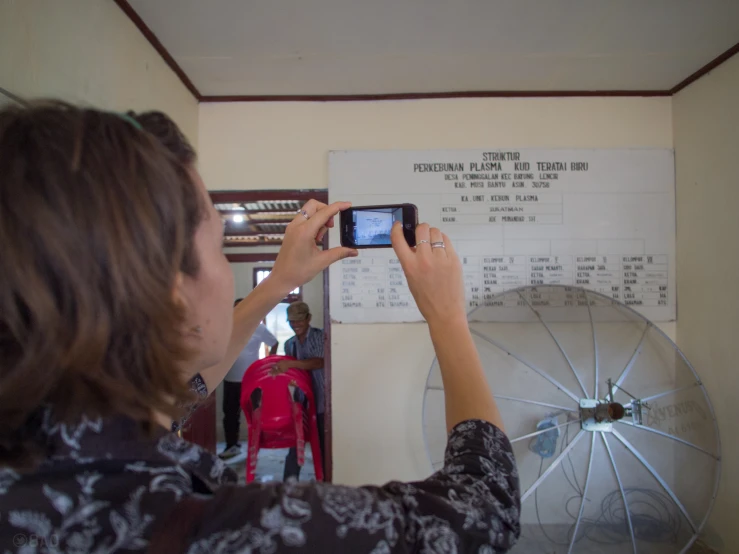 a woman that is taking a po with a phone