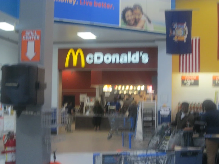a mcdonalds store with a lot of people inside of it