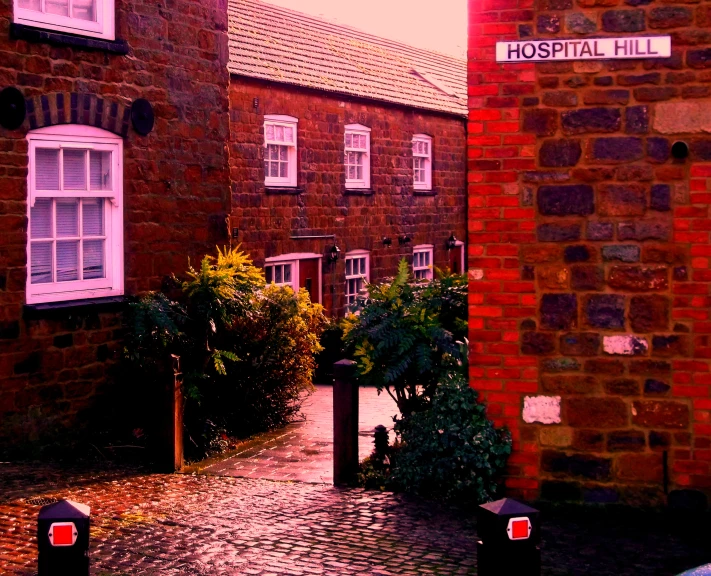 there is a red brick building and several planters on the sidewalk