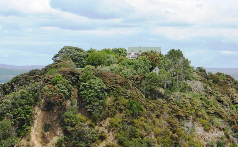 a very small house perched on top of the mountain