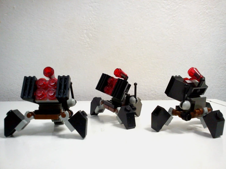 three small robots made out of legos