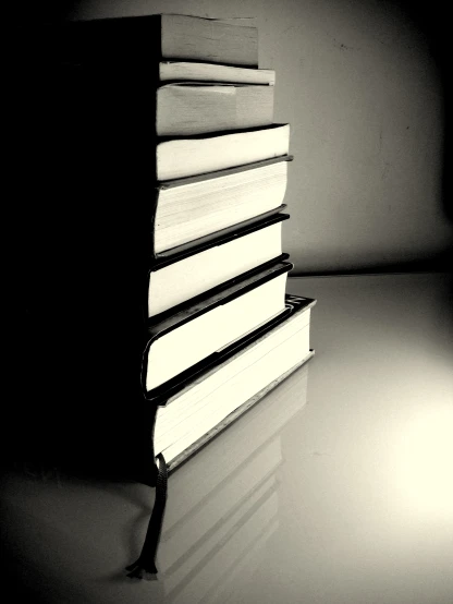 there is a black and white po of books stacked