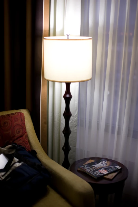 a chair and a table with a lamp on it