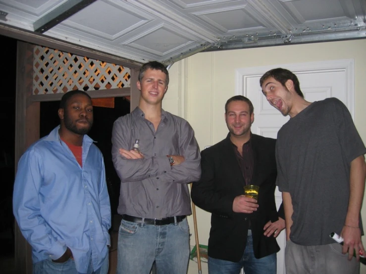 three guys with their drinks smiling at the camera