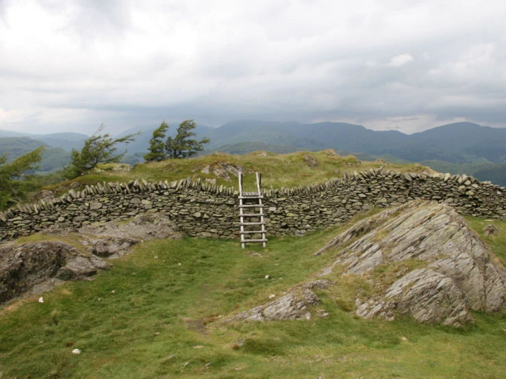 ladders in a stone wall along the side of a mountain