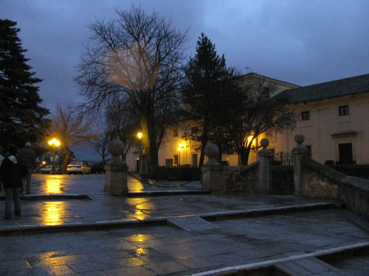 several people walking down an alley at night