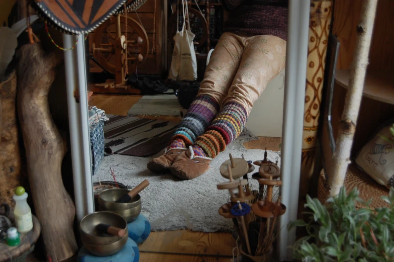 a person sitting in front of a mirror covered in socks