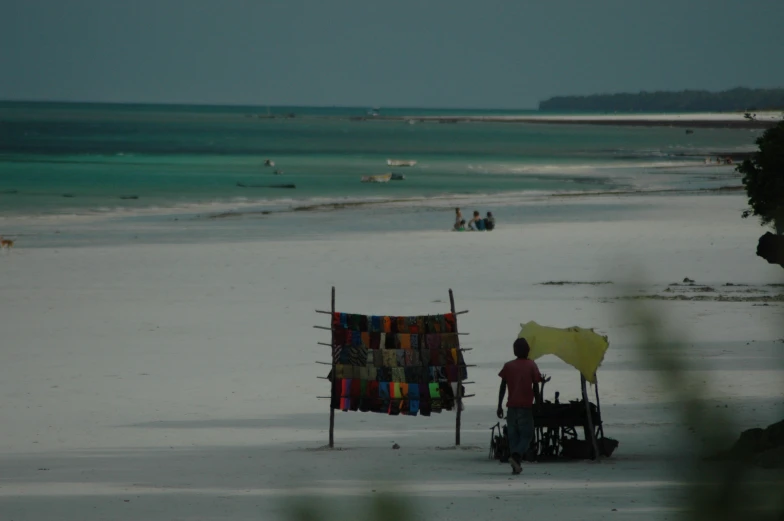 a person holding a laundry line on the beach