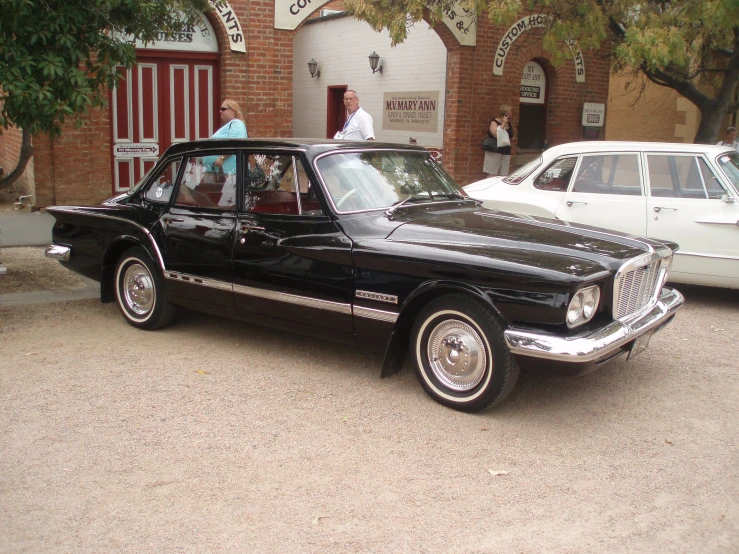 a black car parked next to a building