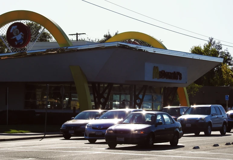 cars parked in front of a building and a car in the parking lot