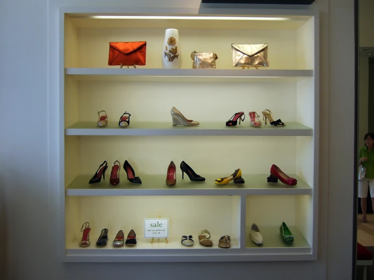 a shelf with several pairs of shoes on it