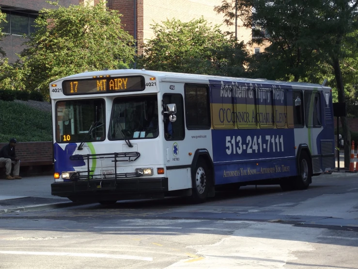 a bus is moving along the street on a sunny day