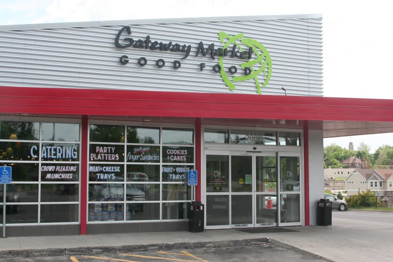 an outdoor parking lot and building with signs advertising business