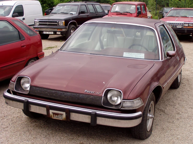 an image of a maroon car with the front grill missing