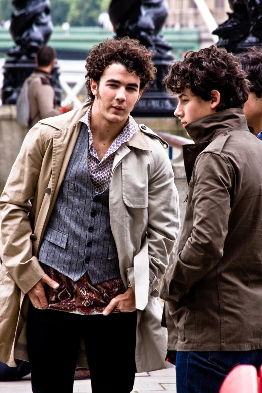 a man and a woman talking together on a sidewalk