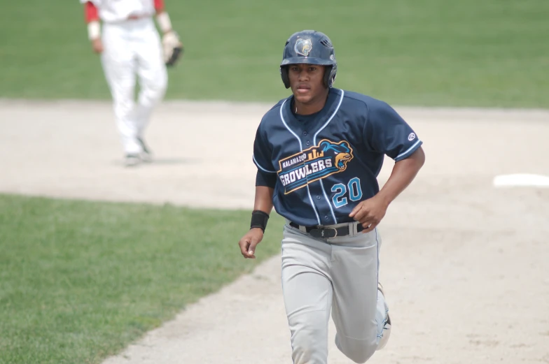 a baseball player running down a baseball field