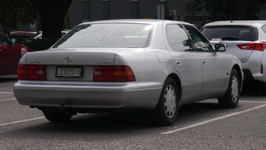 some cars are parked in a lot next to each other