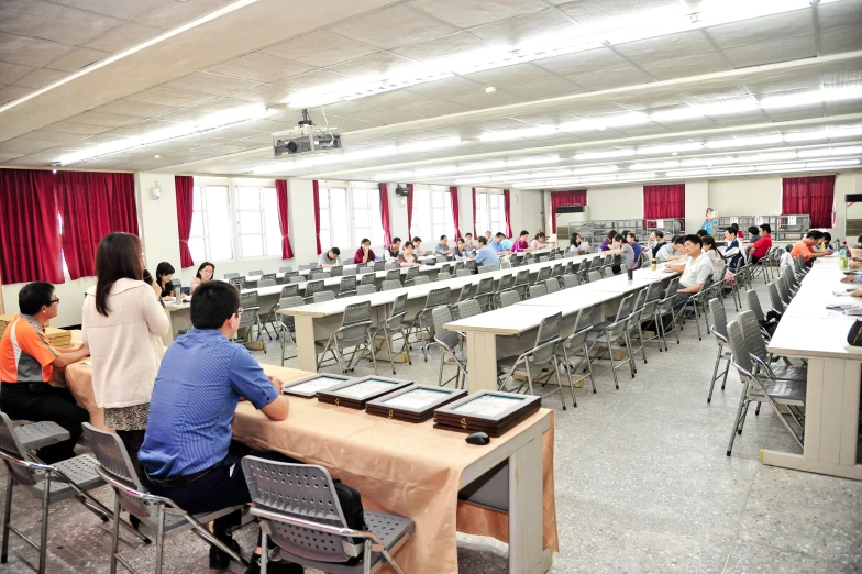 a large conference hall with long tables and chairs