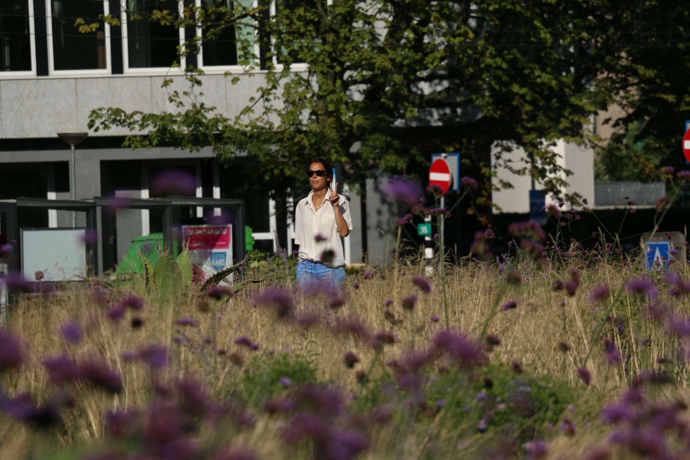 man taking pos through tall grasses and trees