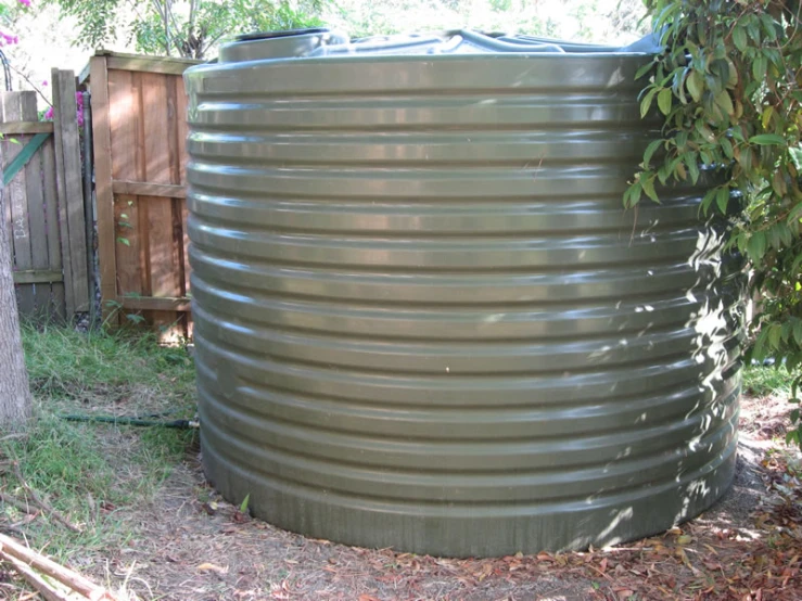 a large metal tub is next to the house