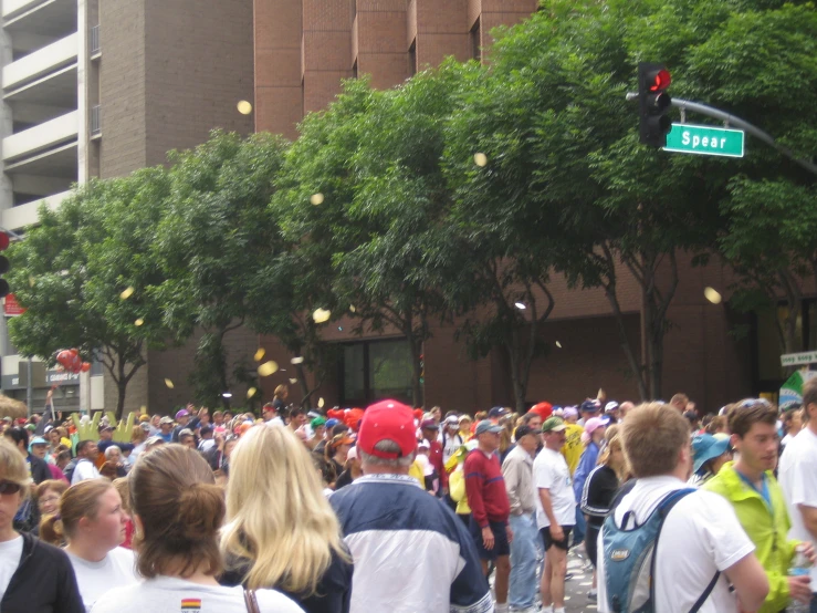 many people walking down the street in a parade