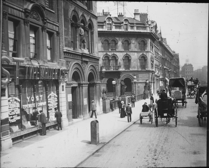 a couple of horses are pulling a carriage down the street