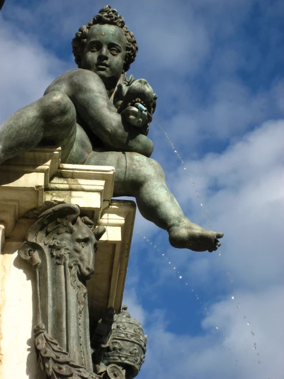 a statue of a young man holding a baby