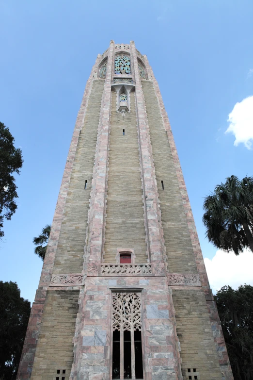 the large brick clock tower has carvings on it