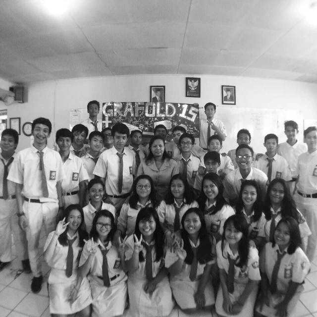 black and white pograph of a group of people posing for a po