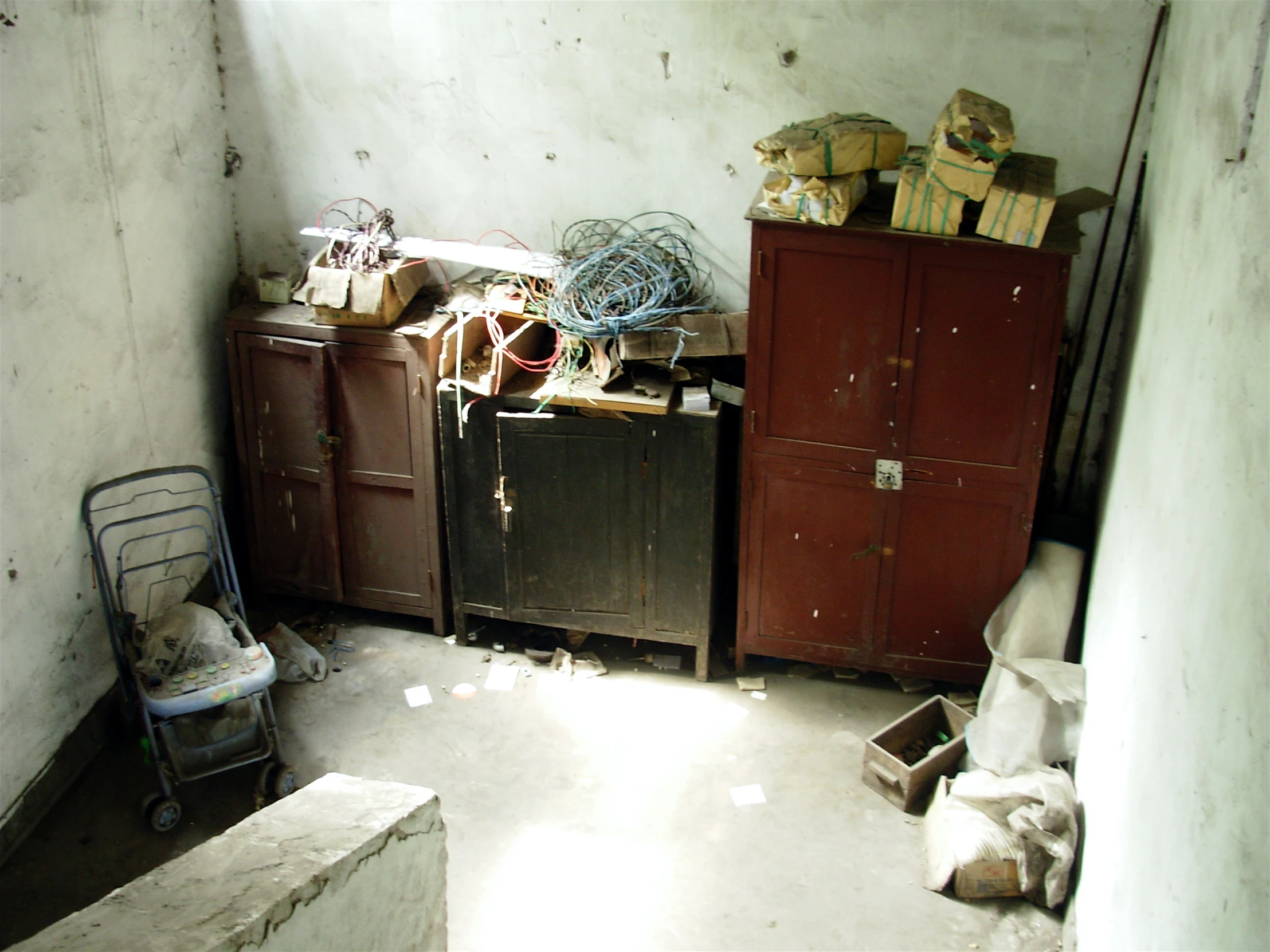 two small baby changing tables in a run down room