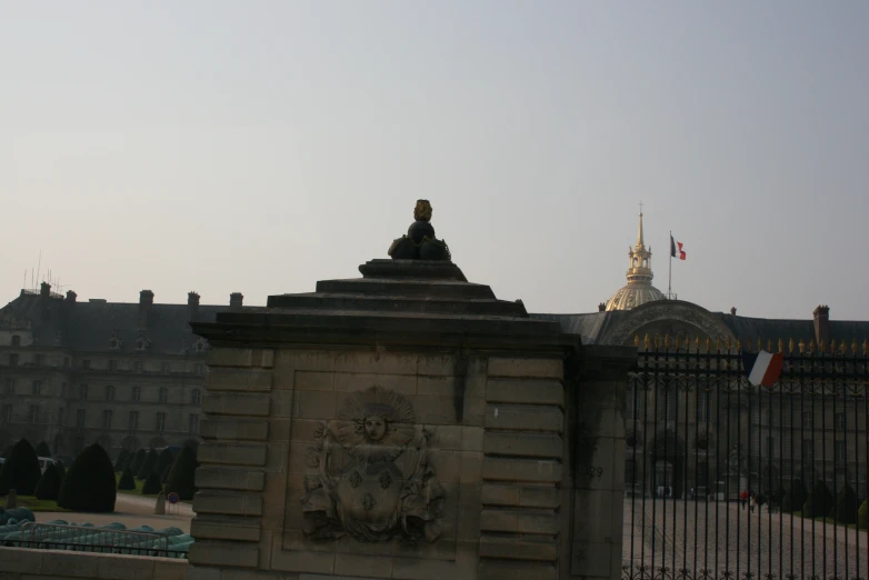 a statue of a woman on a pedestal atop a wall