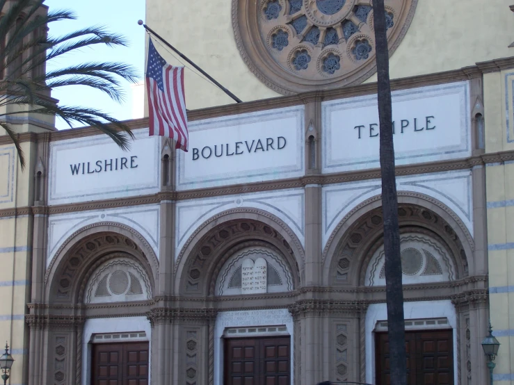 a large building with two american flags on the flagpole