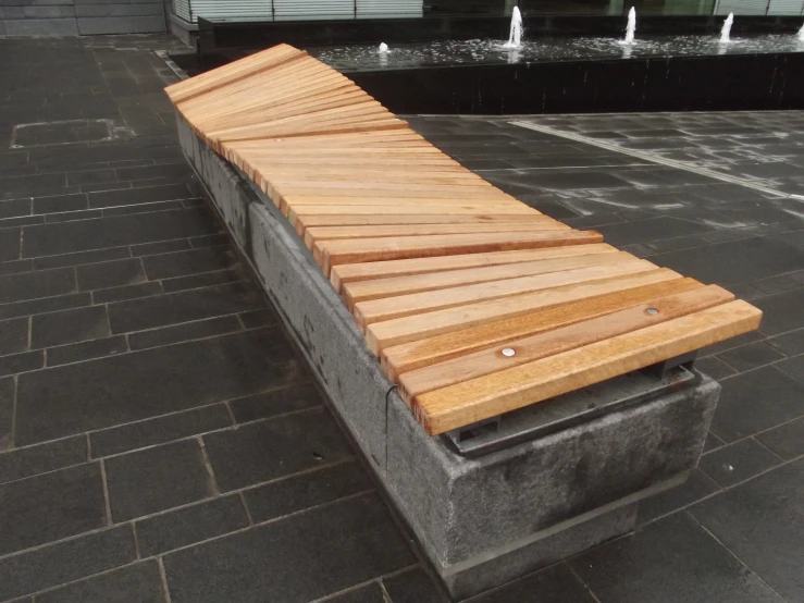 there is a bench that has wooden slats on it