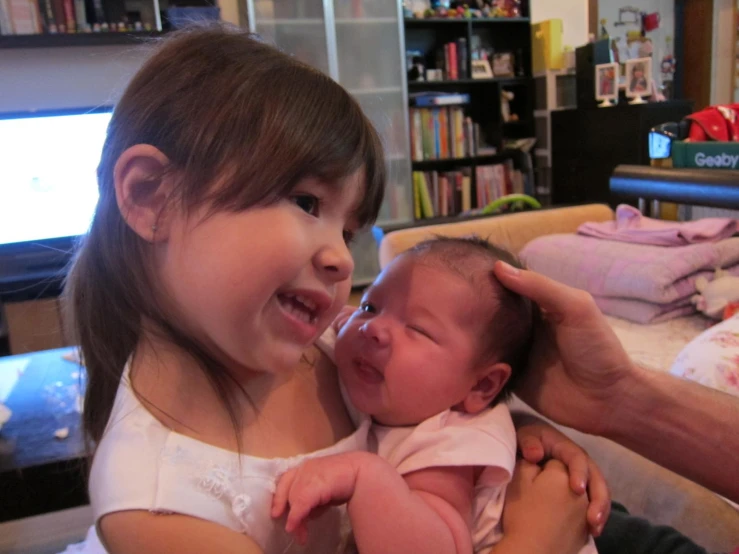 a baby crying while the mom holds her