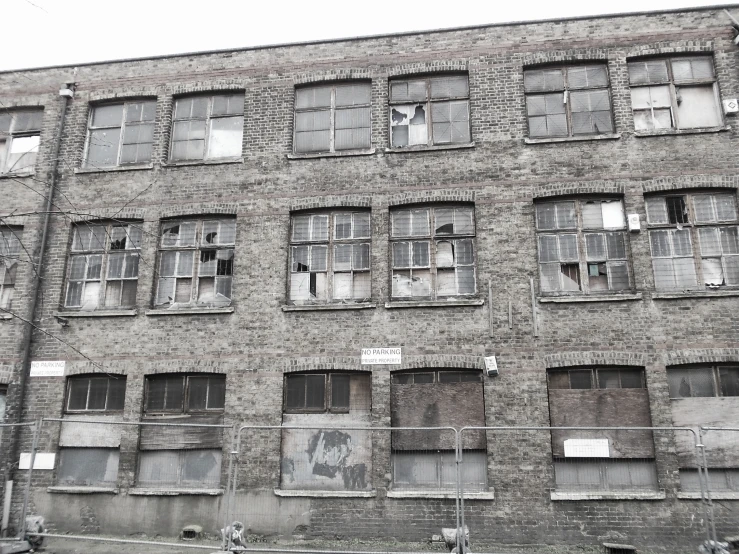 an old brick building has several windows on it