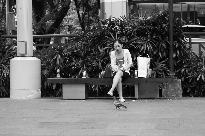 a person sitting on a bench while on the phone