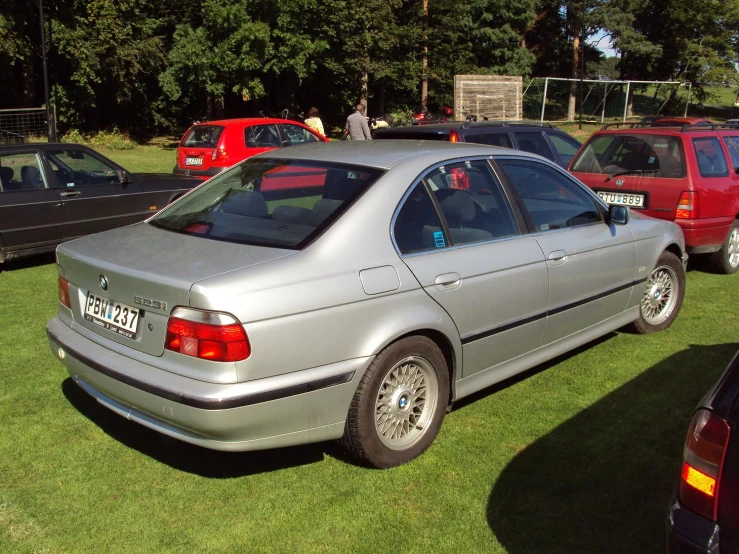 the cars are parked on a grass field