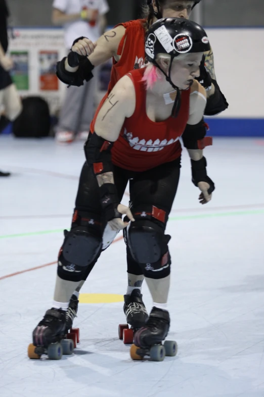 a pair of people in gear skate together