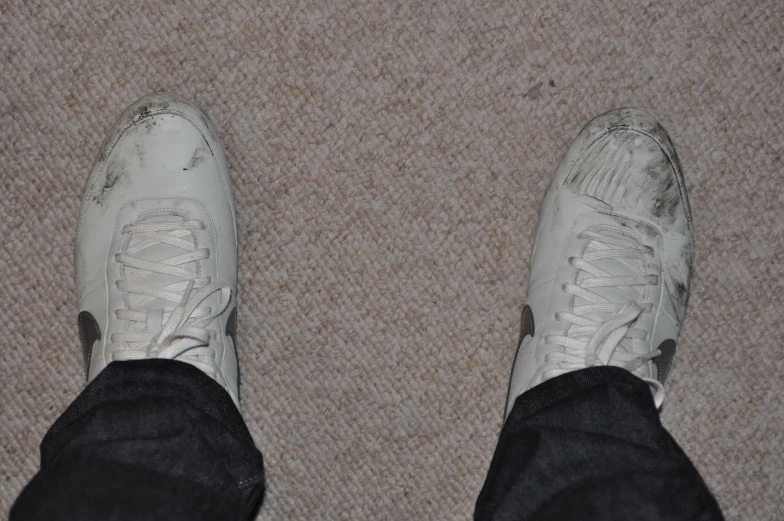 a close up view of a persons shoes on a carpet