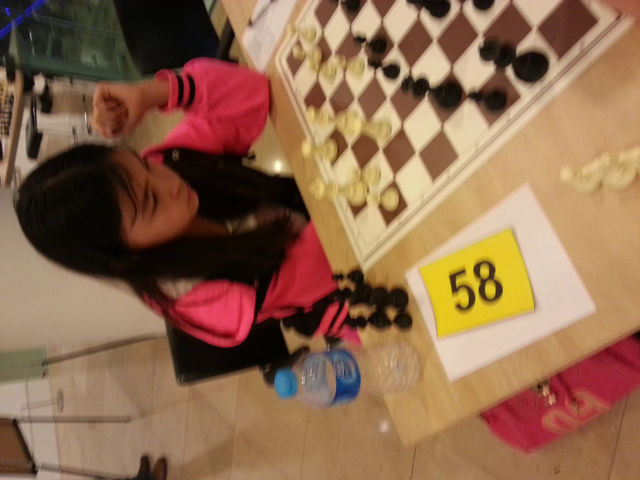 a girl playing chess and making numbers on the board